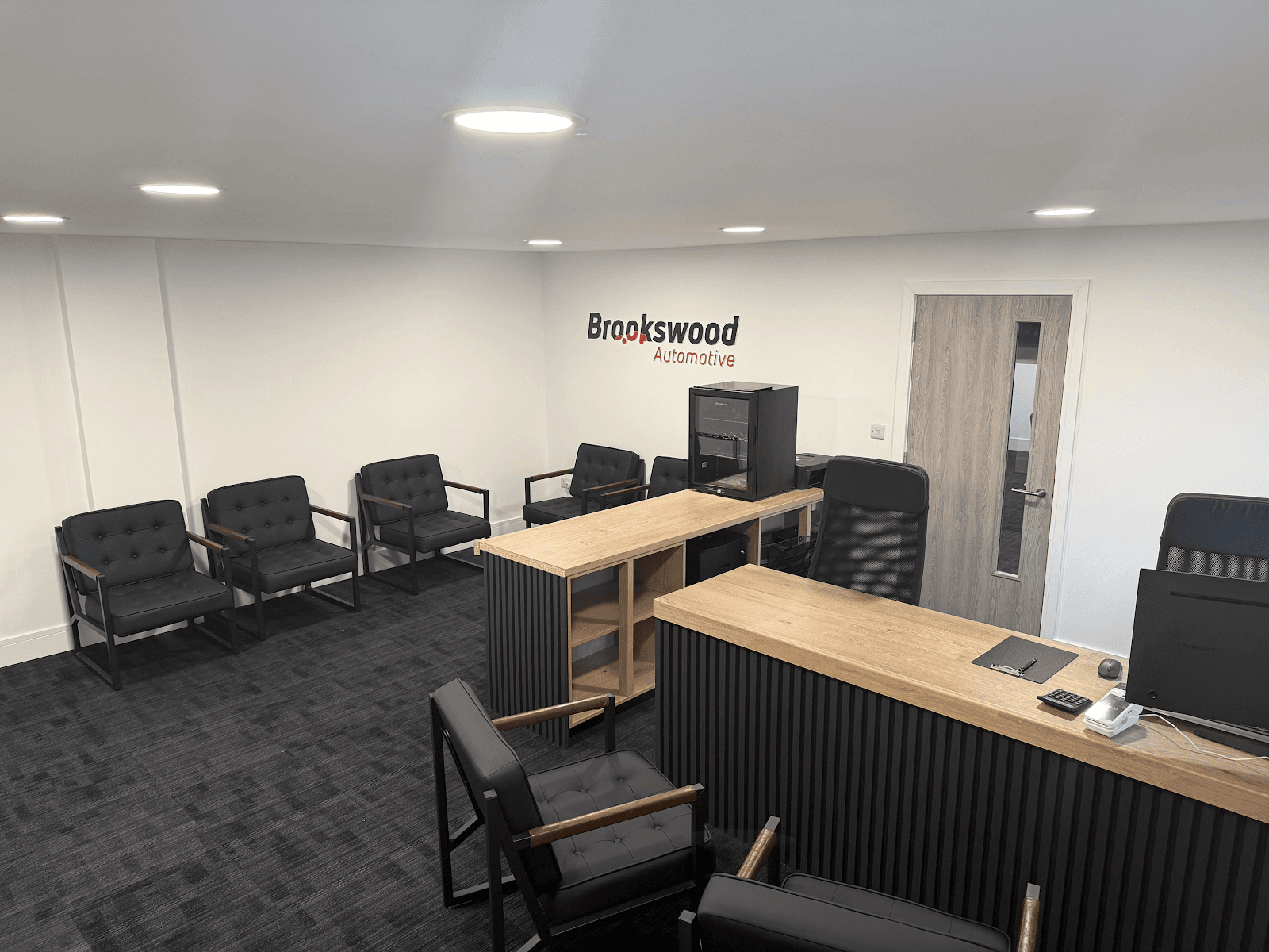 Modern customer waiting area and reception desk inside the Brookswood Automotive garage